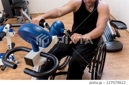 Disabled man training in the gym. Rehabilitation center 127079622