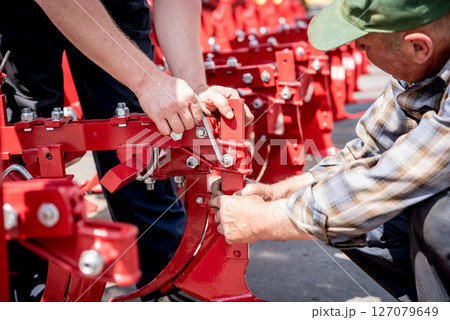 The mechanics repair combine harvester. Modern agricultural machinery 127079649