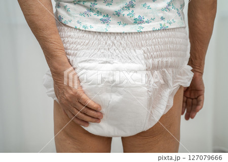Asian senior woman patient wearing adult incontinence diaper pad in hospital. Asian senior woman patient wearing adult incontinence diaper pad in hospital. 127079666