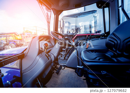 Modern tractor cabin interior. Agricultural exhibition. Industrial Modern tractor cabin interior. Agricultural exhibition. Industrial 127079682
