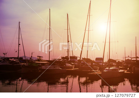 Beautiful view of marina and harbor with yachts and motorboats. Beautiful view of marina and harbor with yachts and motorboats. 127079727
