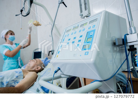 Doctor give resuscitation to patient in the emergency room. Cardiac massage Doctor give resuscitation to patient in the emergency room. Cardiac massage 127079772