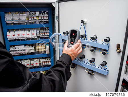 Electrical measurements with multimeter tester. Modern electrical background. 127079786