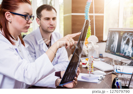 Two doctors having medical council in hospital. Discussing medical issues. 127079790