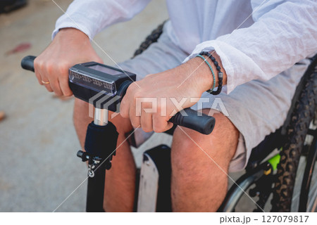 Disabled man in a wheelchair with electric scooter on the beach Disabled man in a wheelchair with electric scooter on the beach 127079817