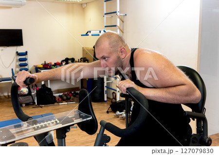 Disabled man training in the gym. Rehabilitation center Disabled man training in the gym. Rehabilitation center 127079830