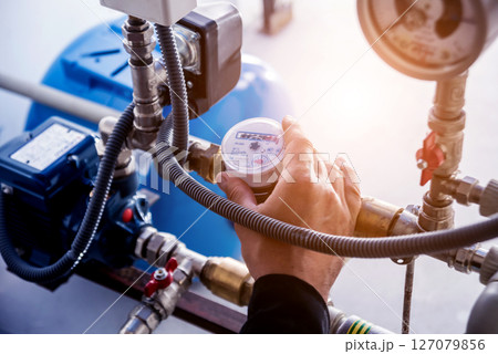 Technician checking water system nodes.Modern Industrial background 127079856
