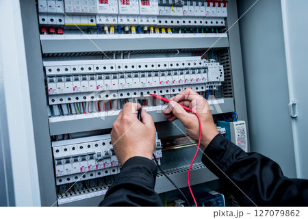 Electrical measurements with multimeter tester. Modern electrical background. 127079862