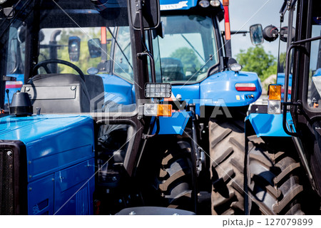 Rows of modern tractors. Industrial details. Agricultural Rows of modern tractors. Industrial details. Agricultural 127079899