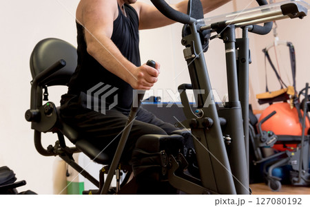 Disabled man training in the gym. Rehabilitation center Disabled man training in the gym. Rehabilitation center 127080192