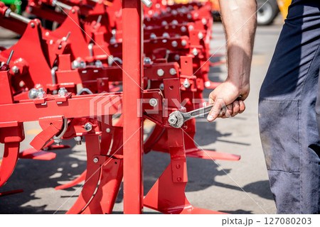 The mechanics repair combine harvester. Modern agricultural machinery 127080203