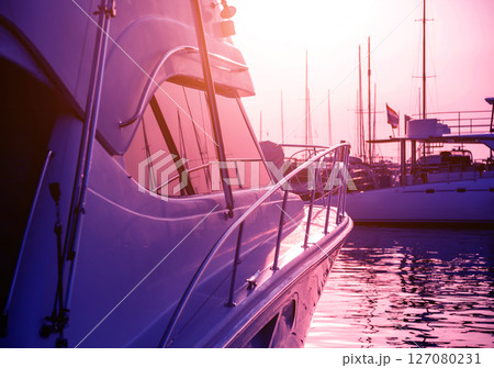 View of harbor with yachts details. Beautiful sunset sky in the marina bay. 127080231