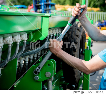 The mechanics repair combine harvester. Modern agricultural machinery 127080444