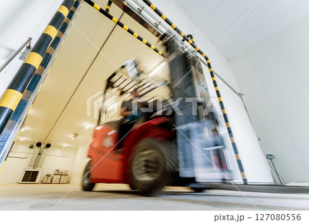 Forklift in a large industrial freezer warehouse. Empty warehouse Forklift in a large industrial freezer warehouse. Empty warehouse 127080556