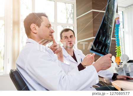 Doctors team having medical council in hospital. Discussing medical issues. Doctors team having medical council in hospital. Discussing medical issues. 127080577