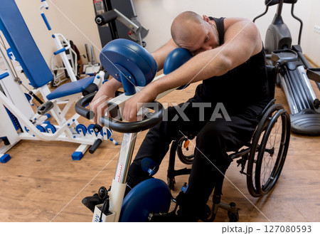 Disabled man training in the gym. Rehabilitation center Disabled man training in the gym. Rehabilitation center 127080593