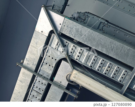 Ceiling with ventilation pipes and lights in industrial building Ceiling with ventilation pipes and lights in industrial building 127080890