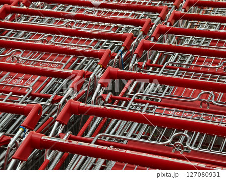 A row of shopping carts is neatly lined up in a straight row 127080931