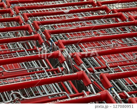 A row of shopping carts is neatly lined up in a straight row A row of shopping carts is neatly lined up in a straight row 127080951