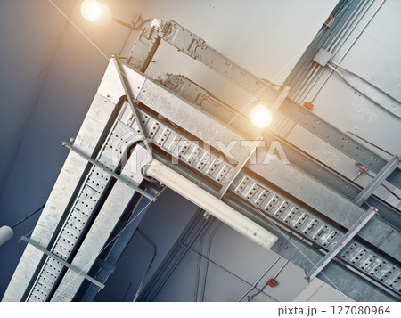 Ceiling with ventilation pipes and lights in industrial building 127080964