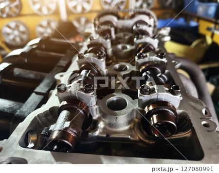 A car engine is being worked on inside a garage workshop 127080991