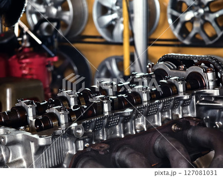 A car engine is being worked on inside a garage workshop 127081031