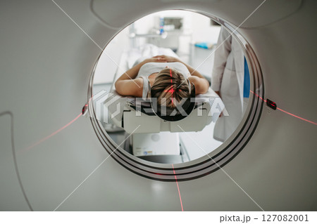 Patient positioned for head scan with laser alignment in CT scanner 127082001