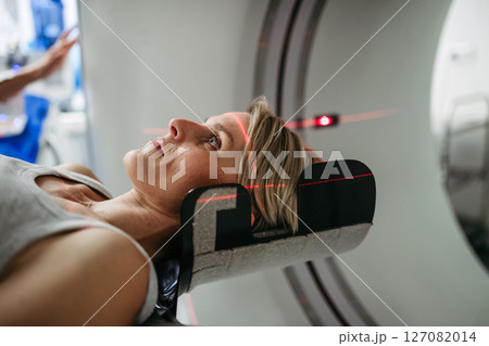 Patient positioned for head scan with laser alignment in CT scanner 127082014