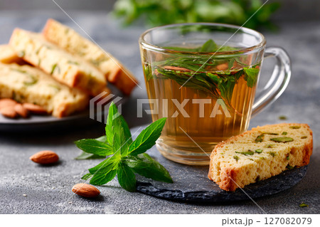 elegant presentation of herbal tea paired with almond biscotti 127082079