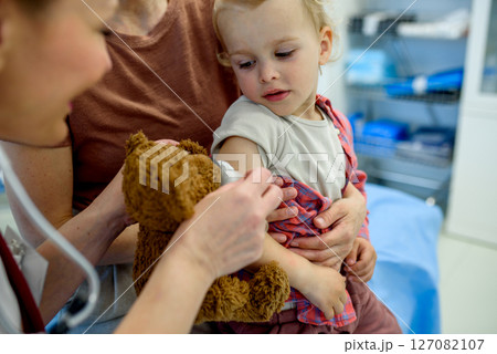 Doctor placing cotton and medical tape on the injection spot. 127082107