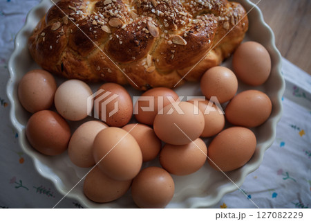 Homemade braided bread and eggs on rustic kitchen table 127082229