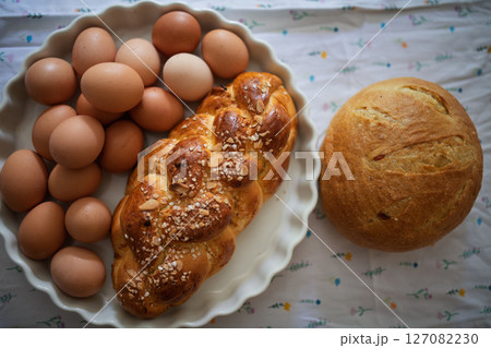 Homemade bread and eggs on rustic kitchen table Homemade bread and eggs on rustic kitchen table 127082230