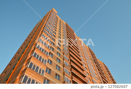 multi-storey new yellow brick house against the blue sky. Mortgage, real estate, new housing, copy space. multi-storey new yellow brick house against the blue sky. Mortgage, real estate, new housing, copy space. 127082687