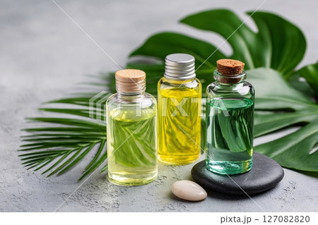 aromatherapy oils on marble with tropical leaves, wellness spa concept, mood relaxation 127082820