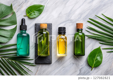 aromatherapy oils on marble with tropical leaves, wellness spa concept, mood relaxation 127082821