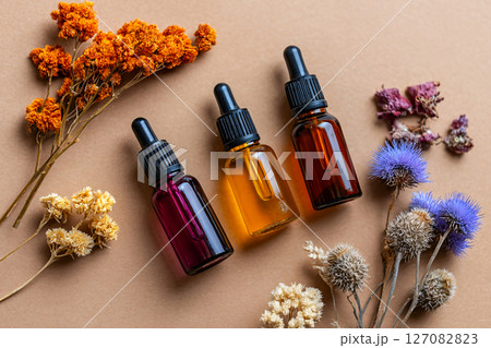 minimalist flat lay of essential oil bottles, dried flowers, calm mood background 127082823