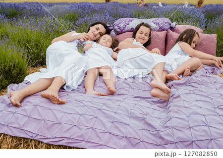 The family is resting in the middle of a fragrant lavender field The family is resting in the middle of a fragrant lavender field 127082850