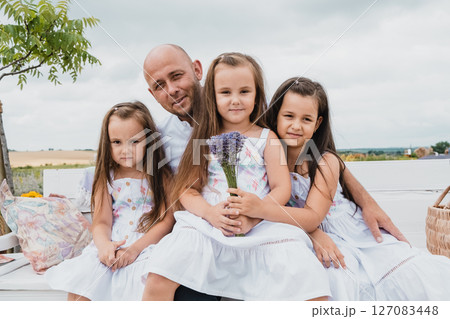 The father spends time with his three daughters in the lavender field 127083448