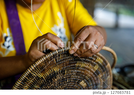 Mangyan Village Talipanan Oriental Mindoro Philippines closeup of hands weaving basket from bamboo fibers 127083781