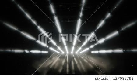 Powerful geometric light beam patterns cutting through artificial fog creating volumetric illumination at dark music venue 127083792