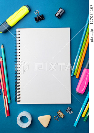 Bright school supplies on a blue background 127084167