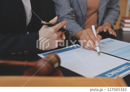 Judge gavel with Justice lawyers having team meeting at law firm background. Concepts of Law and Legal services. 127085382