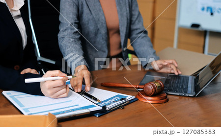 Judge gavel with Justice lawyers having team meeting at law firm background. Concepts of Law and Legal services. Judge gavel with Justice lawyers having team meeting at law firm background. Concepts of Law and Legal services. 127085383