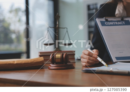Judge gavel with Justice lawyers having team meeting at law firm background. Concepts of Law and Legal services. Judge gavel with Justice lawyers having team meeting at law firm background. Concepts of Law and Legal services. 127085390