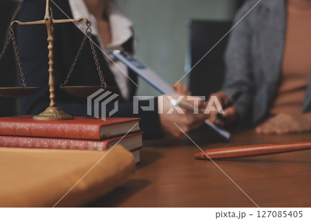 Judge gavel with Justice lawyers having team meeting at law firm background. Concepts of Law and Legal services. Judge gavel with Justice lawyers having team meeting at law firm background. Concepts of Law and Legal services. 127085405