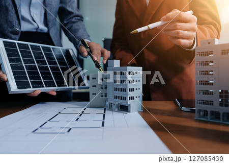 Discussion among businesspeople on the latest developments in solar cell panel technology and Solar Energy Environment city Concept. Discussion among businesspeople on the latest developments in solar cell panel technology and Solar Energy Environment city Concept. 127085430