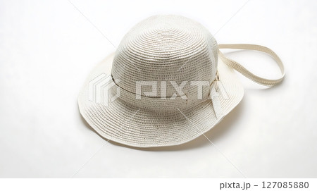 A white hat with a white strap is laying on a white background 127085880
