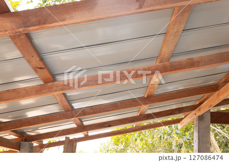Roof under construction with metal sheet and wood structure. 127086474