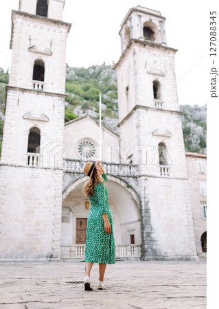 Happy female tourist in beautiful dress walking in the street of the city. Fashion style. Travel. 127088345
