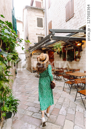 Young woman in beautiful dress walking in the street of the city. Eurotrip. Travel, tourism. Fashion 127088364